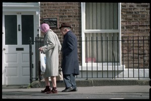 Older man and woman walking down Pembroke Road, Dublin, across from the U.S. embassy