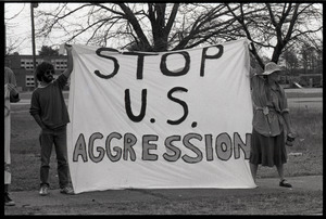 Protests against U.S. intervention in Nicaragua at Westover Air Force base: two protesters holding a banner reading 'Stop U.S. aggression'