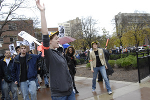 UMass student strike: strike organizer with a bullhorn, leading the march past the Du Bois Library