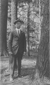 William J. Fahey, Jr. standing outdoors, in forest