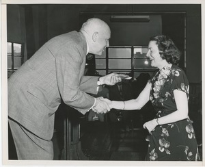 Unidentified man handing prize to client at Institute Day