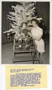 Monica Vermeulen and her doll with physical therapist at Christmas party