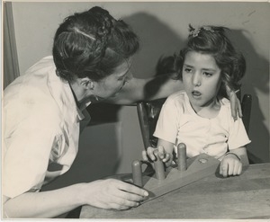 Physical therapist helping young girl with coordination