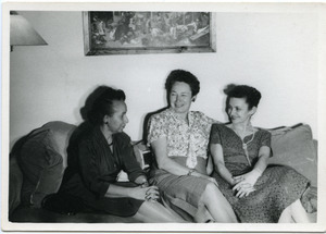Shirley Graham Du Bois, seated on a sofa with two unidentified women