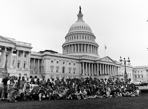 Congressman John W. Olver with large group of visitors, posed in front of the United States Capitol building
