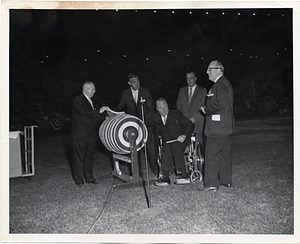 Mayor John F. Collins drawing a raffle ticket