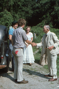 Hank Art greets Arthur E. Rosenburg as Steven and Charmaine Masters look on at Moon Barn Raising at entrance to Hopkins Forest on 2 August 1975.