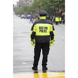 A Boston Police officer watches over Copley Square during the "One Run" race