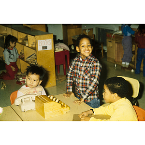 Young children at a table playing with toys