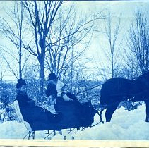 Marjorie Gray in sleigh with her grandfather and mother