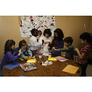 Children working at a table on art projects