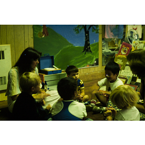 Young children seated on the floor in a circle