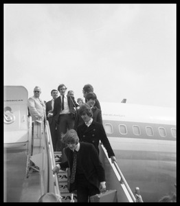 Ringo Starr, George Harrison, Paul McCartney, and John Lennon descending the ramp from a Pan American airways Boeing 707