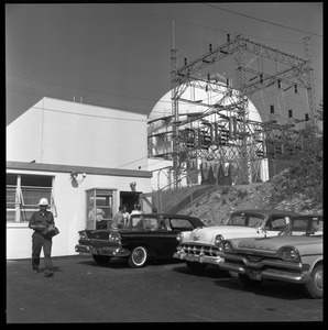 Yankee Atomic: worker leaving the plant. with parked cars and spherical containment building in background
