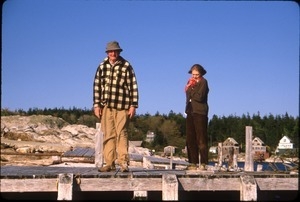 Harry and Betsy Hollins on dock of their homestead at mouth of Kennebec River