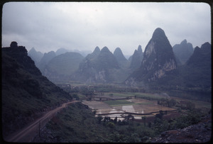 Paddies in valley, mountains behind