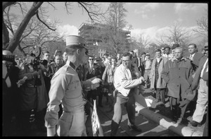 American Nazi Party counter-protester Douglas L. Niles, in uniform, walking past media and onlookers: Washington Vietnam March for Peace