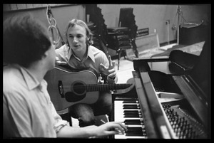 Stephen Stills with his guitar talking with Michael Sahl on piano at Wally Heider Studio 3 during production of the first Crosby, Stills, and Nash album