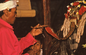 Male performer waving incense