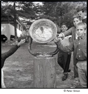 Camp Arcadia: boys ringing a bell