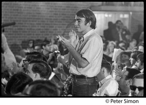 Audience member applauding at the National Student Association Congress, watching debate between Timothy Leary and Sidney Cohen on 'social philosophy'