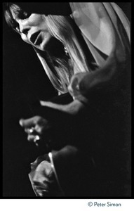 Joni Mitchell, playing guitar