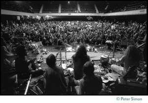 View from the stage of the audience in the Winterland Ballroom during the Ram Dass 'marathon', looking over the band Amazing Grace