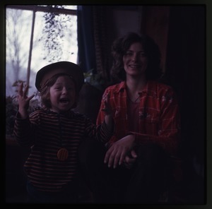 Nina Keller and young child (Eben?), inside house at Montague Farm Commune