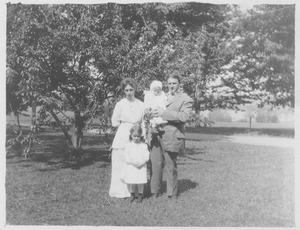 H. L. Barnes with wife and children standing outside