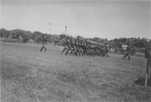 ROTC members march across a campus field