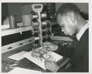 Man wiring a peg board