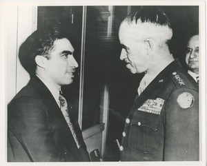 Two men, one with military insignia