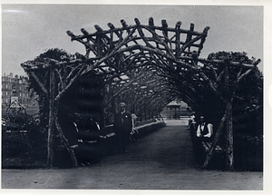 People under a wooden arbor in Boston Common