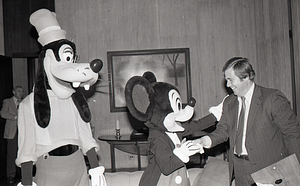 Man with Disney characters Mickey Mouse and Goofy