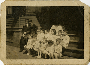 Children dressed in white, sitting on steps