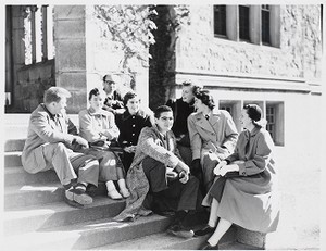 Boston College students sitting on steps of campus building