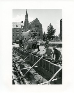 O'Neill Library exterior under construction with workers and cement truck