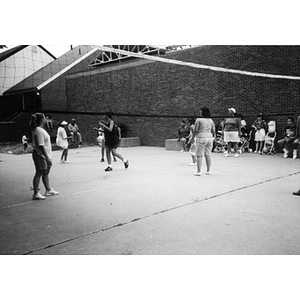 Women playing volleyball.