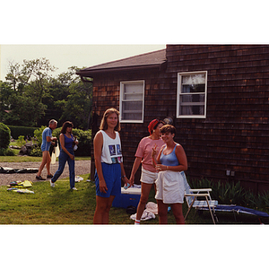 Three women stand together in front of a house at a Boys & Girls Club Board outing