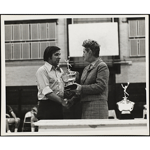 Coach Jack Sandurus receives a senior division trophy in a Boys' Club basketball tournament