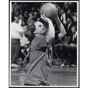 Former New England Patriot Randy Vataha preparing to shoot a basketball at a fund-raising event held by the Boys and Girls Clubs of Boston and Boston Celtics