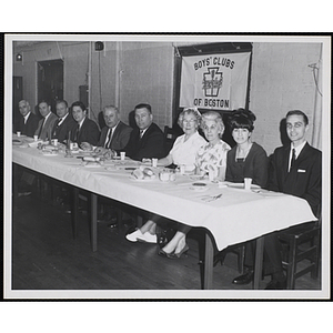 Women and men sit at the head table during a Father and Son's Supper