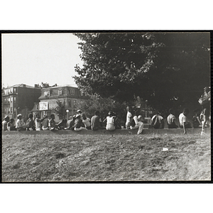 A group of youth sit on a street curb