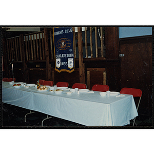 A row of tables is set with plastic cups and plates at the Charlestown Kiwanis Club