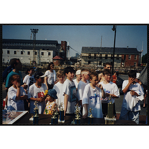 A group of children stand at a table of trophies during the Battle of Bunker Hill Road Race