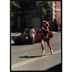 A woman runs in the Battle of Bunker Hill Road Race
