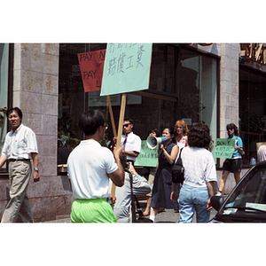 Demonstrators picket outside Dynasty Restaurant to get back wages for workers