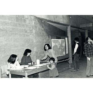 Guests in the lobby of the Josiah Quincy School before a program about the normalization of U.S. and China relations