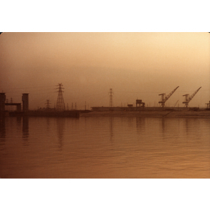 Cranes and power lines on the horizon of a Chinese harbor