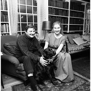 Rudolph Morris poses with his wife and their dog in their home library